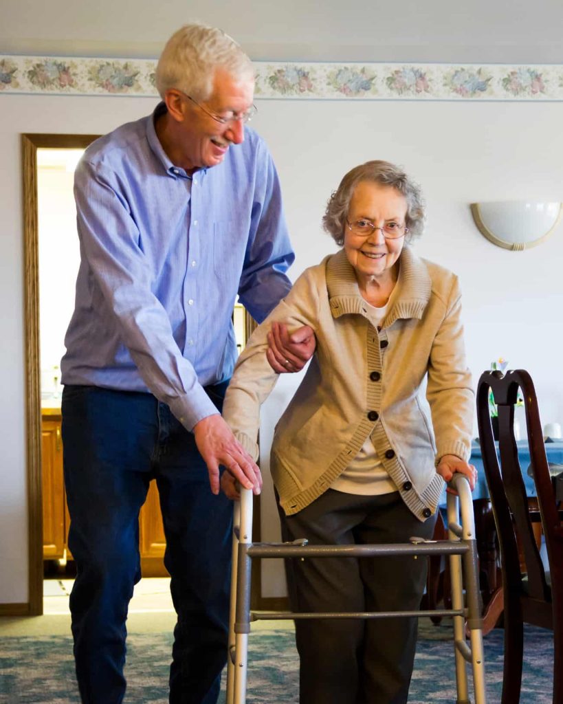 the old man helps his wife after his Hip Surgery . The hip replacement success stories